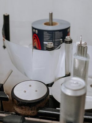 Detailed view of a brewery machinery used for labeling beer cans in an industrial setting.